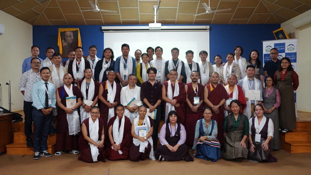 Group photo of 31 established Tibetan scholars on Tibetan studies.